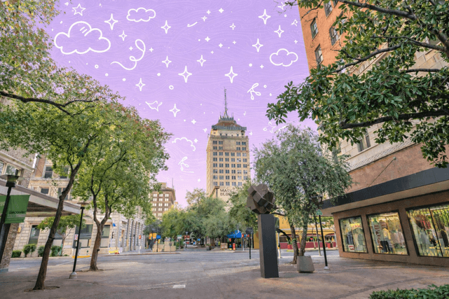Downtown Fresno California street scene with historic buildings, trees, sculpture, and the Pacific Southwest Building rising above the city plaza