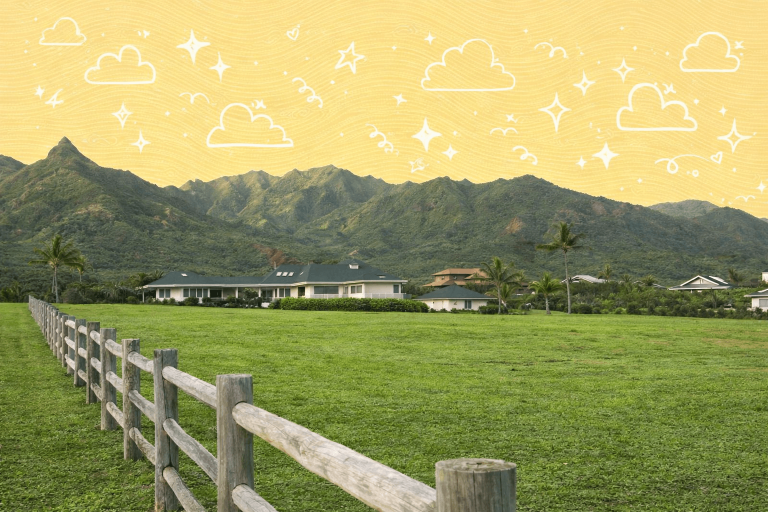 Scenic view of homes with lush green lawns and mountains in Kauai, Hawaii.
