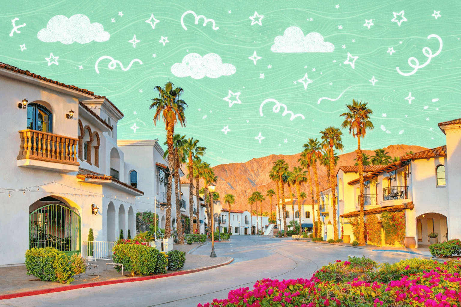Spanish style homes and palm lined street in a residential neighborhood in La Quinta California with desert mountains at sunset.
