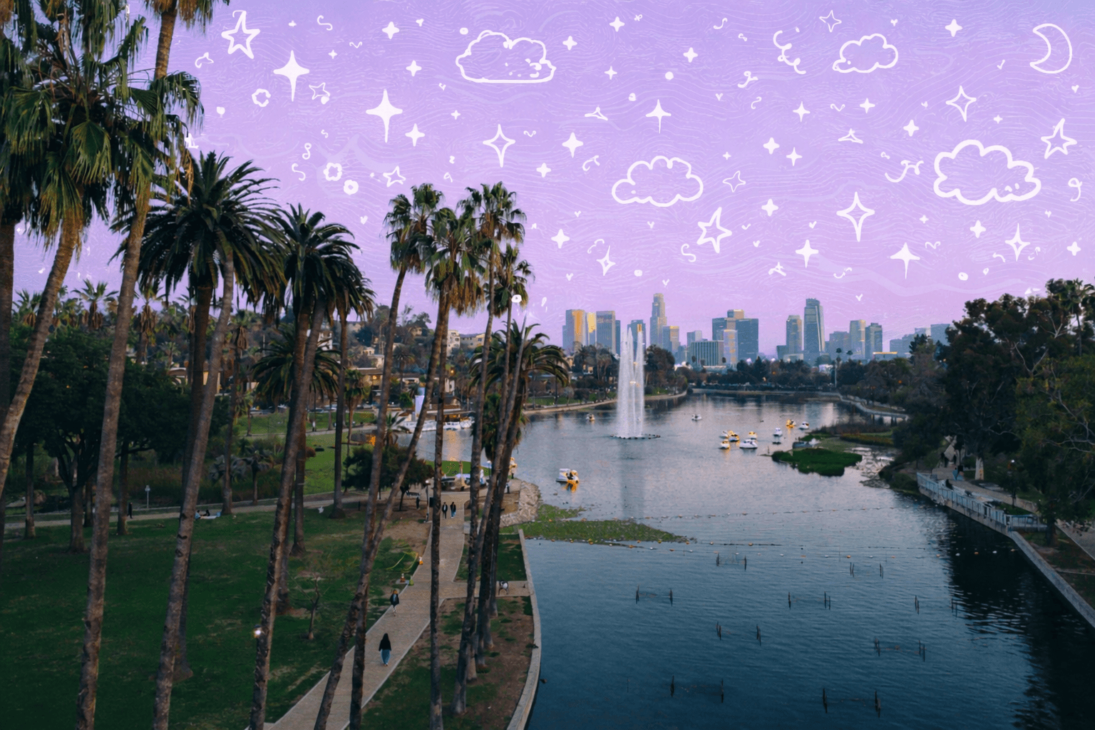 Echo Park Lake with palm trees, swan paddle boats, and the downtown Los Angeles skyline in the background at sunset.