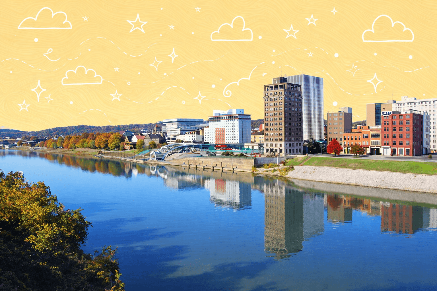 Downtown Charleston, WV skyline with scenic river view reflecting buildings on a sunny day.