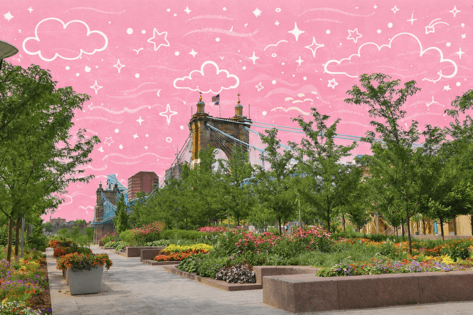 Riverfront park walkway with landscaped gardens and the Roebling Suspension Bridge in Cincinnati Ohio on a sunny day.