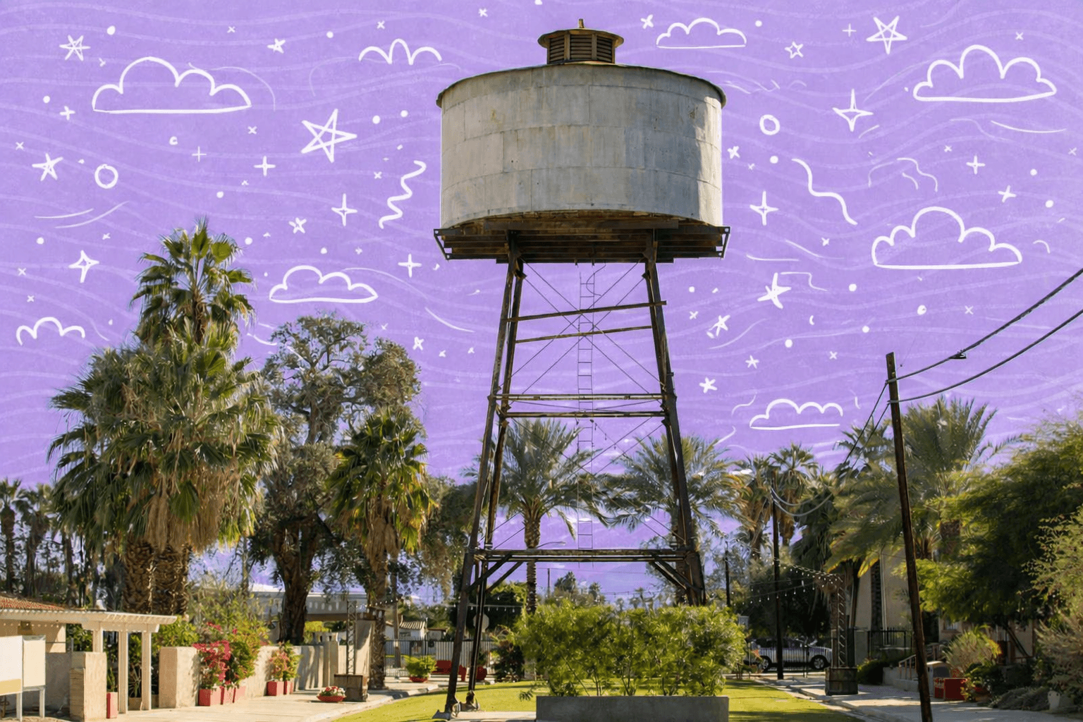 Historic metal water tower surrounded by palm trees and desert landscaping in Indio, California neighborhood park