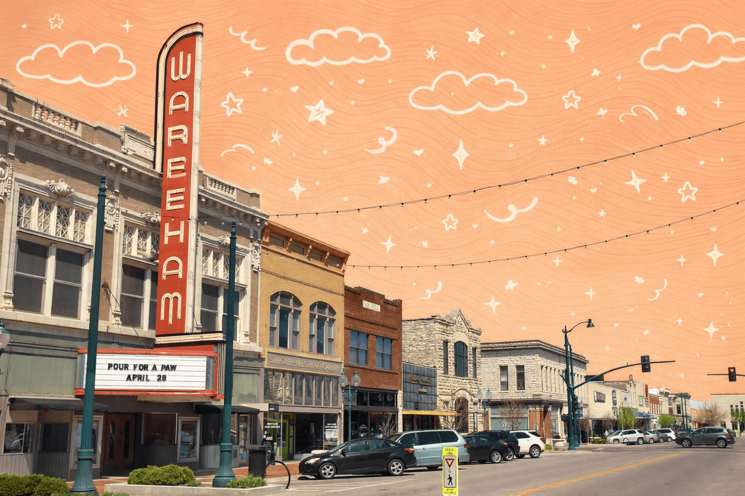 Historic downtown Manhattan, Kansas featuring the Wareham Theater marquee and storefronts along Poyntz Avenue with parked cars.