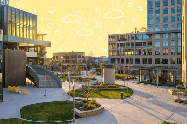 Sunrise over modern office buildings and landscaped green spaces in a Boise business district.