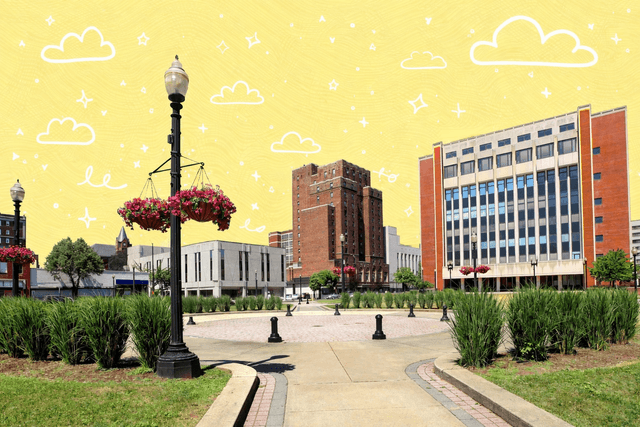 Downtown park and city buildings in Bridgeport Connecticut on a sunny day with landscaped walkways and flowers