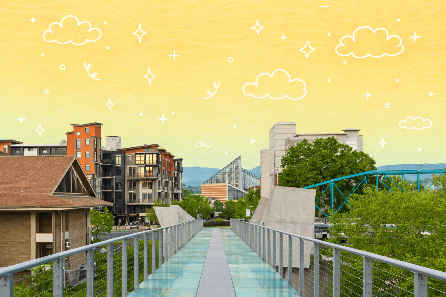 Glass bridge in Chattanooga, TN with modern buildings and scenic views.
