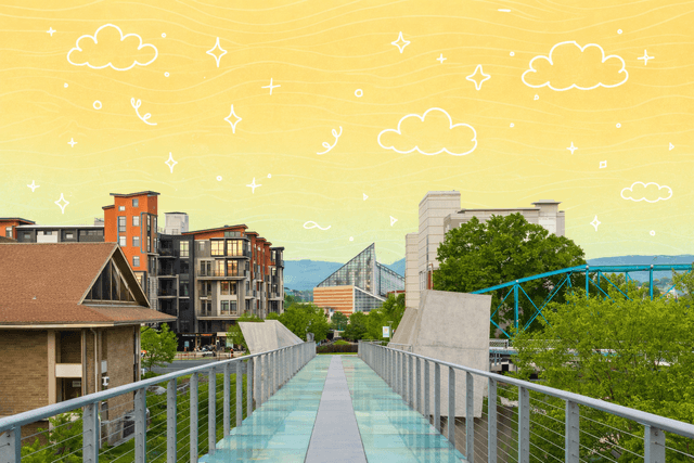 Glass bridge in Chattanooga, TN with modern buildings and scenic views.
