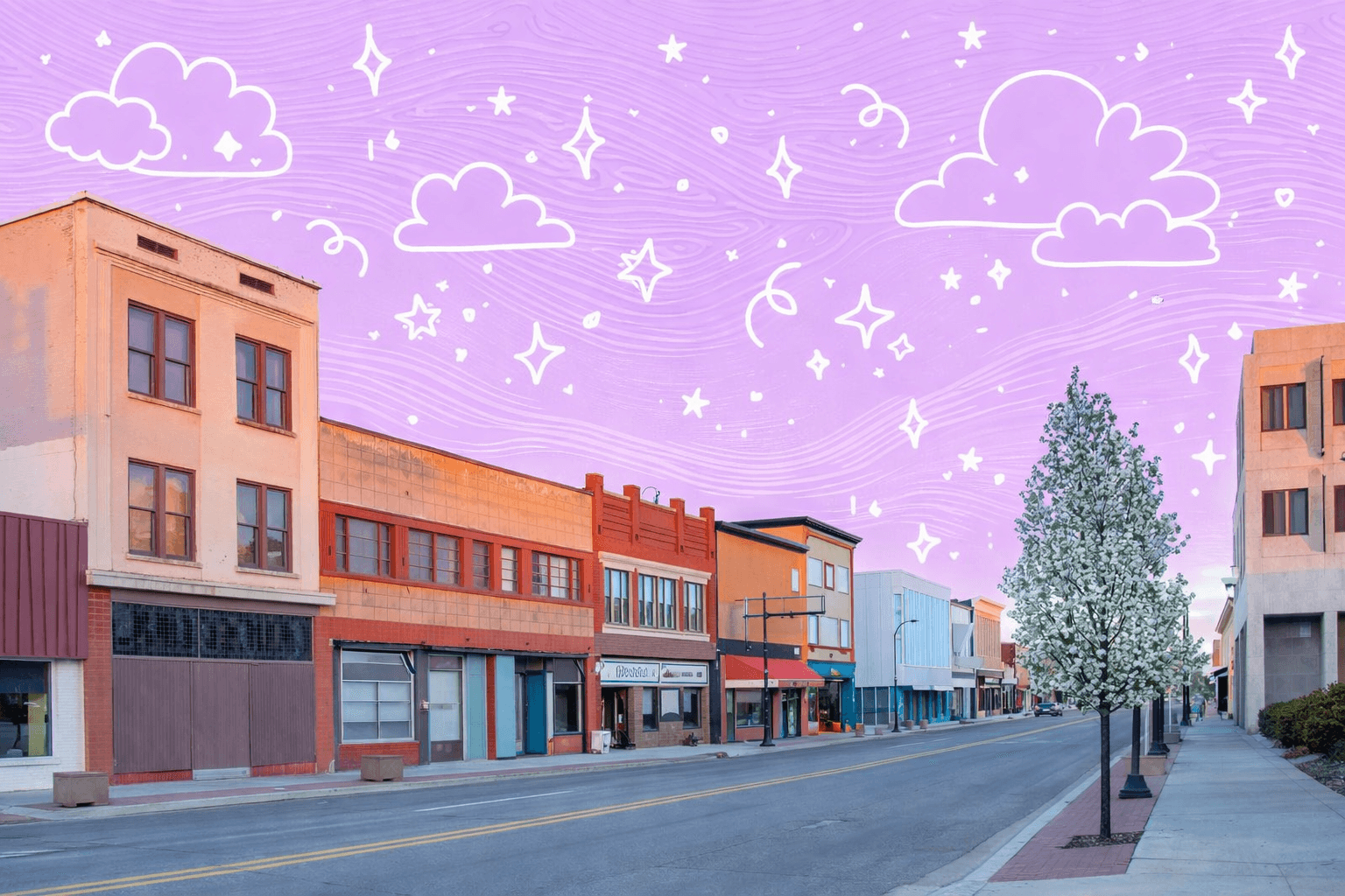 Street view of downtown Idaho Falls, ID with historic buildings and a flowering tree.