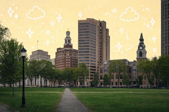 New Haven cityscape featuring a park with historic and modern buildings in the background, showcasing a blend of architecture in Connecticut.