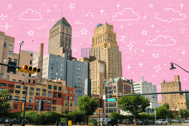 Downtown Newark New Jersey skyline with historic high rise buildings and street level traffic on a sunny day